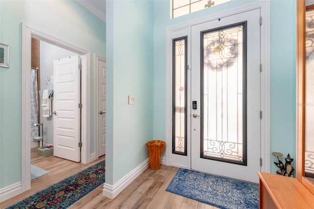 entrance foyer with light wood-style floors and baseboards