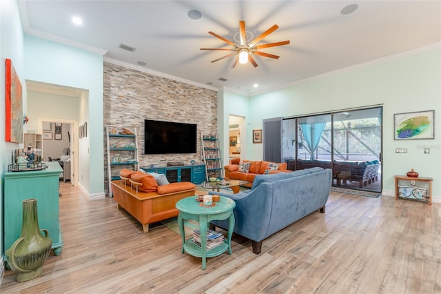 living area with light wood-style floors, visible vents, ornamental molding, and baseboards