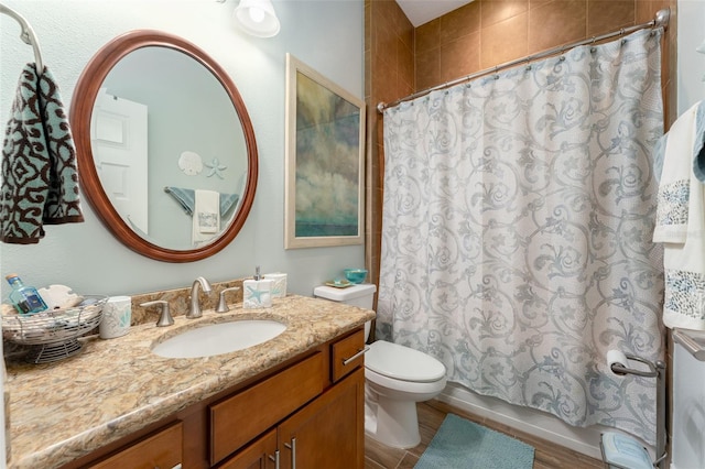 full bathroom with toilet and vanity