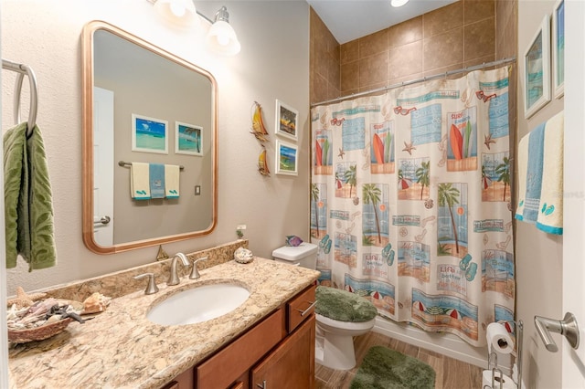 full bathroom featuring wood finished floors, vanity, toilet, and shower / bathtub combination with curtain