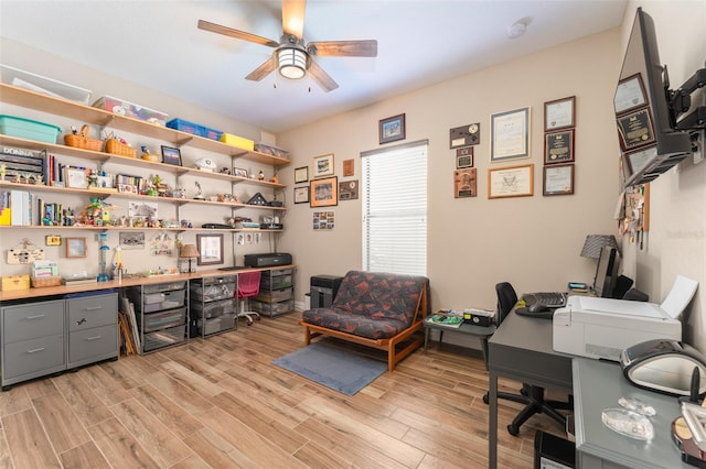 office area with light wood-style flooring and ceiling fan