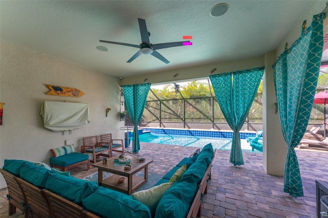 exterior space with an outdoor pool, a lanai, outdoor lounge area, and ceiling fan