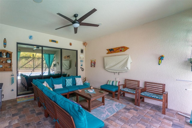 interior space with an outdoor living space and a ceiling fan