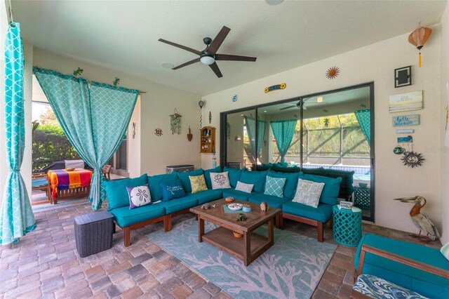 living area with a sunroom and a ceiling fan