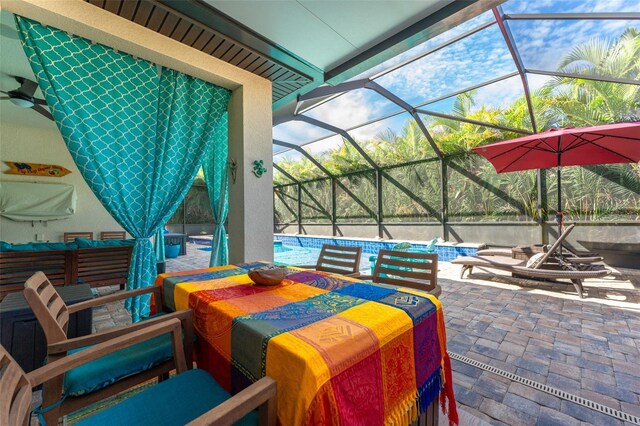 view of patio / terrace featuring glass enclosure and an outdoor pool