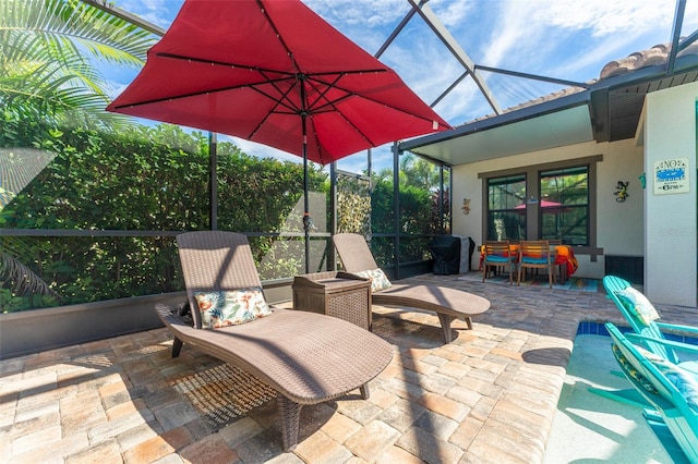 view of patio featuring a lanai