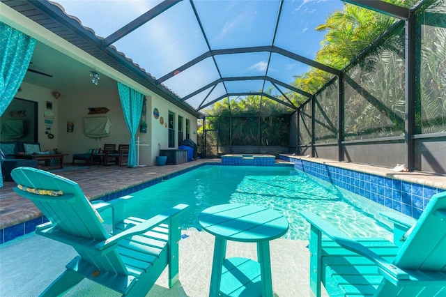 view of swimming pool with a pool with connected hot tub, a patio, and a lanai