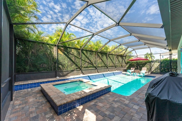 view of pool featuring a lanai, a pool with connected hot tub, grilling area, and a patio