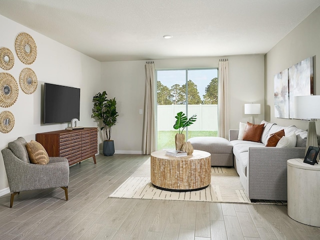 living area featuring baseboards and light wood-style floors