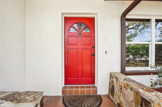 view of exterior entry with stucco siding