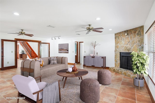 tiled living area with recessed lighting, visible vents, a ceiling fan, and a fireplace