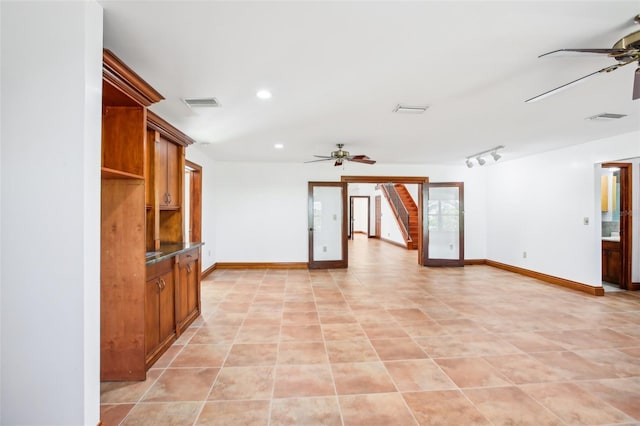 empty room featuring visible vents, recessed lighting, rail lighting, baseboards, and ceiling fan