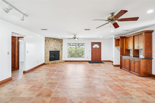 unfurnished living room featuring visible vents, recessed lighting, a fireplace, baseboards, and ceiling fan