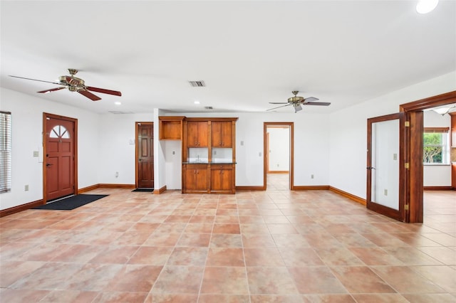 unfurnished living room featuring recessed lighting, visible vents, ceiling fan, and baseboards