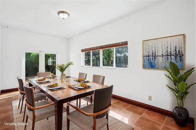 dining room featuring tile patterned flooring and baseboards