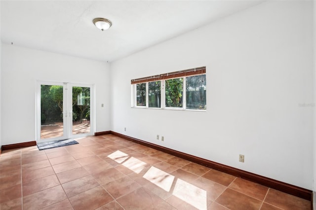 empty room with tile patterned floors and baseboards