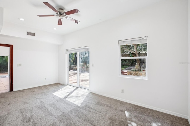 carpeted spare room featuring visible vents, recessed lighting, baseboards, and a ceiling fan