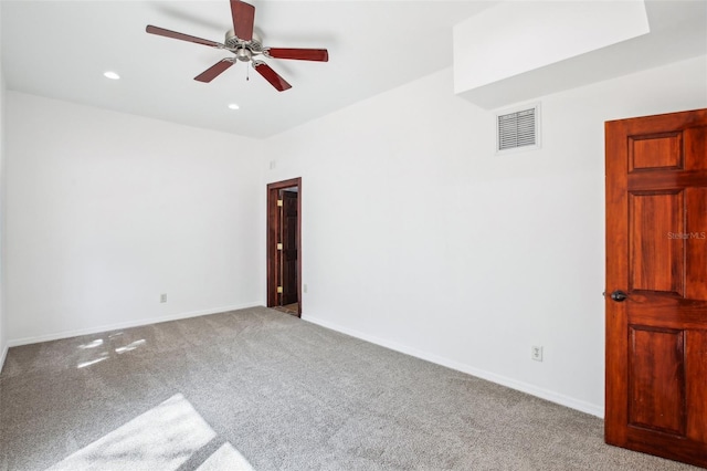 spare room with recessed lighting, carpet flooring, baseboards, and visible vents