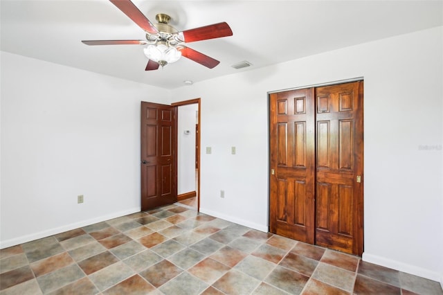 unfurnished bedroom featuring a ceiling fan, baseboards, visible vents, and a closet