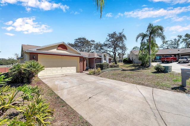 view of front of home with a garage, concrete driveway, and brick siding