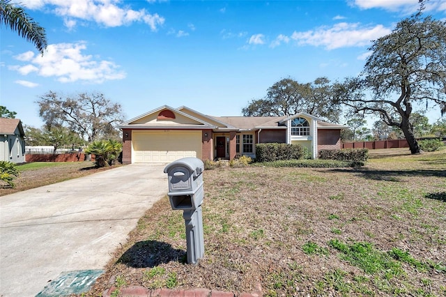 ranch-style home featuring an attached garage, brick siding, fence, concrete driveway, and a front yard