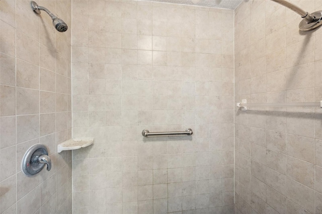 full bath featuring a tile shower