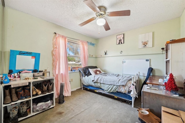 bedroom with carpet floors, ceiling fan, and a textured ceiling