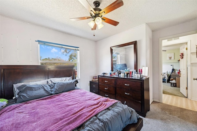 bedroom with a textured ceiling, carpet, visible vents, and a ceiling fan