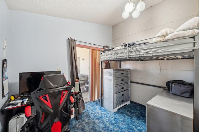 bedroom with a textured ceiling and carpet flooring