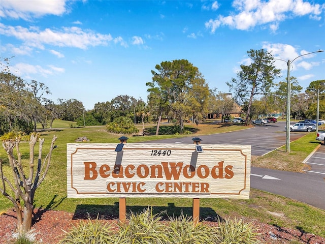 community sign featuring uncovered parking