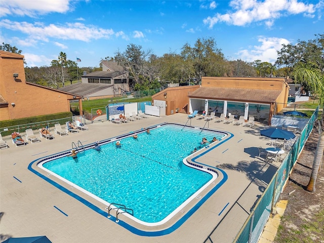 pool with fence and a patio