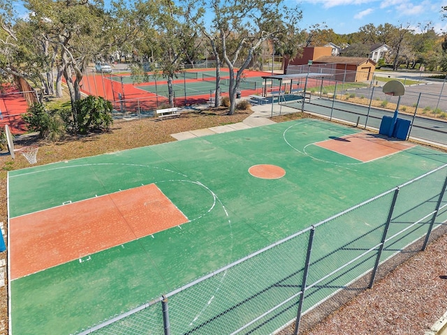 view of sport court featuring a tennis court, community basketball court, and fence