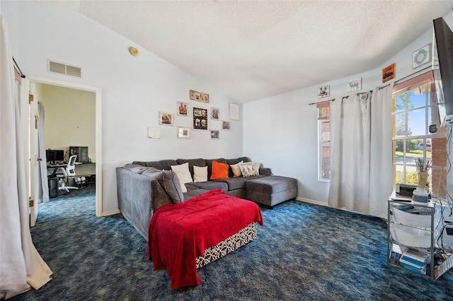 living area with lofted ceiling, carpet flooring, and visible vents