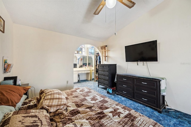 bedroom with vaulted ceiling, carpet, and a ceiling fan