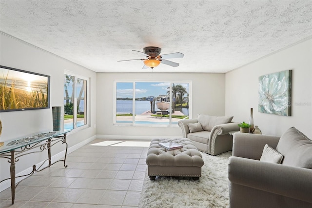 tiled living room featuring a textured ceiling, baseboards, and ceiling fan