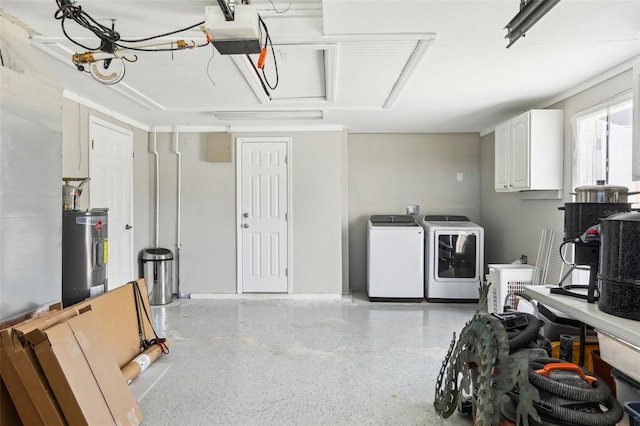 garage with washing machine and dryer, electric water heater, and a garage door opener