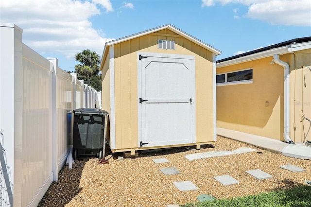 view of shed featuring fence