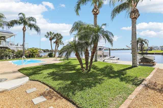 view of yard with boat lift, a boat dock, and a water view