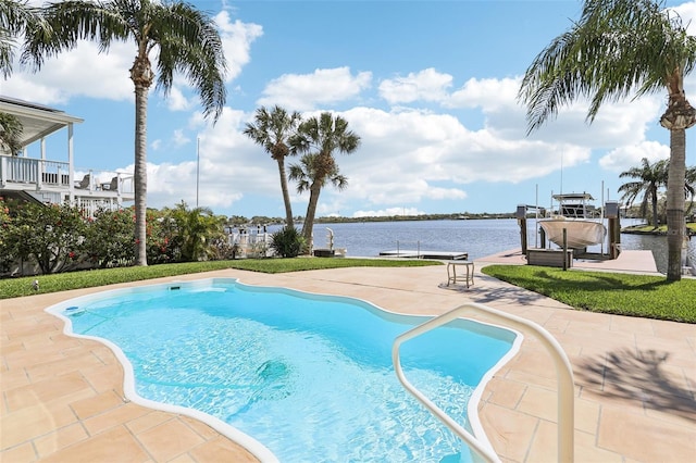 pool with a patio area, boat lift, a boat dock, and a water view