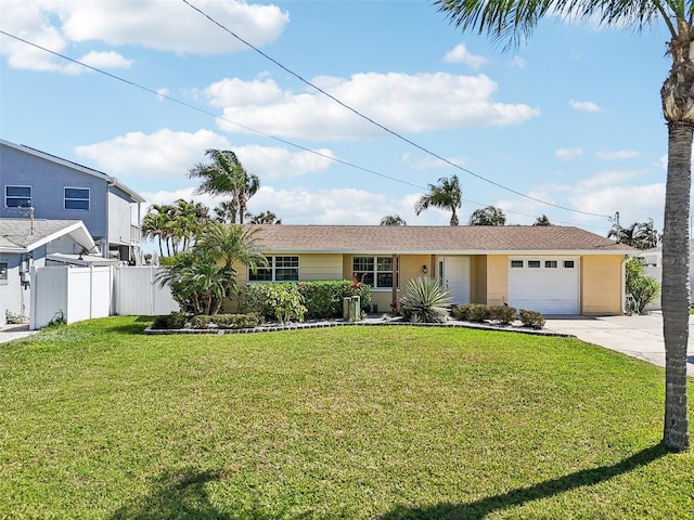 single story home featuring concrete driveway, an attached garage, fence, and a front lawn