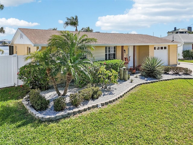 single story home featuring a front yard, a garage, and fence