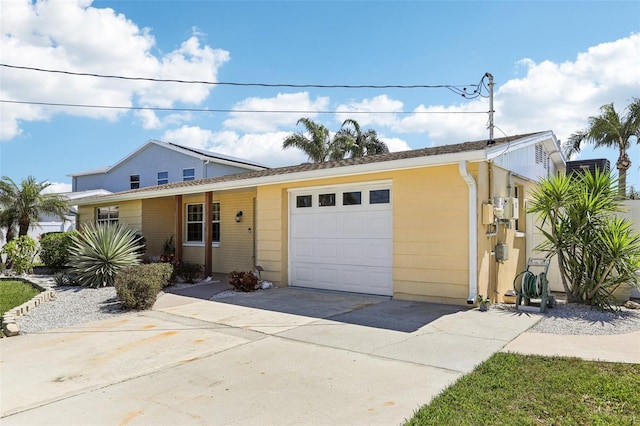 view of front facade with concrete driveway and an attached garage