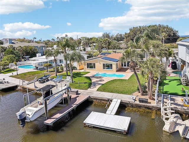 view of dock featuring a yard, a patio area, and a water view