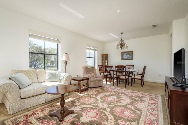 living area with a notable chandelier, visible vents, light carpet, a textured ceiling, and baseboards