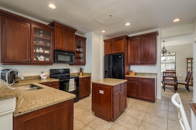 kitchen featuring light tile patterned floors, glass insert cabinets, light stone countertops, black appliances, and a sink