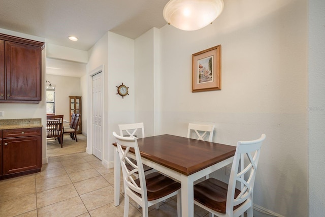 dining space featuring light tile patterned floors, baseboards, and recessed lighting