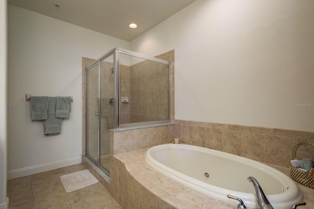 bathroom with baseboards, a garden tub, tile patterned flooring, a textured ceiling, and a shower stall