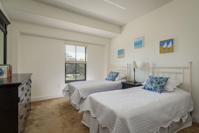 carpeted bedroom featuring baseboards