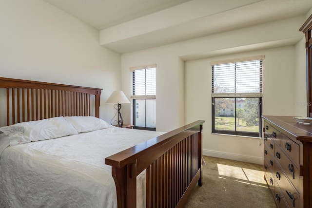 bedroom with light carpet and baseboards