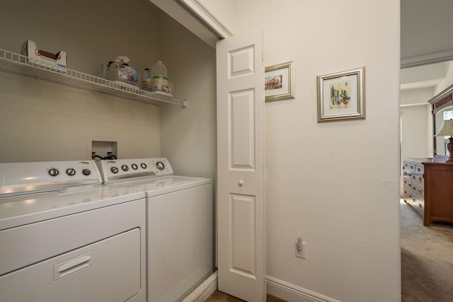 washroom with washing machine and dryer, laundry area, baseboards, and carpet